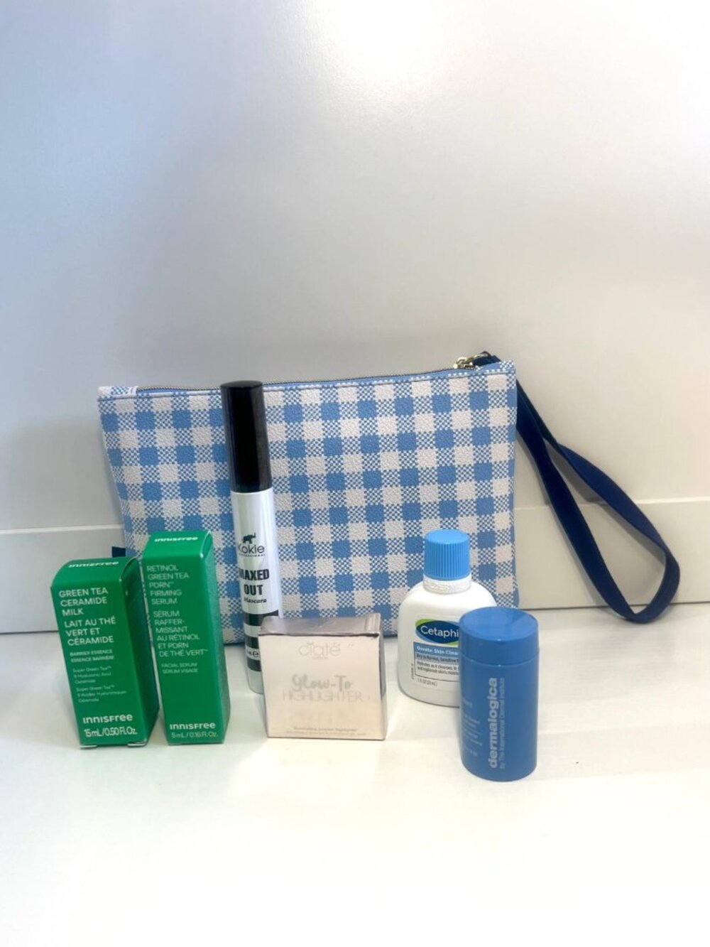 Cosmetic bag with makeup and skincare products (Full, Travel and Sample Sizes)